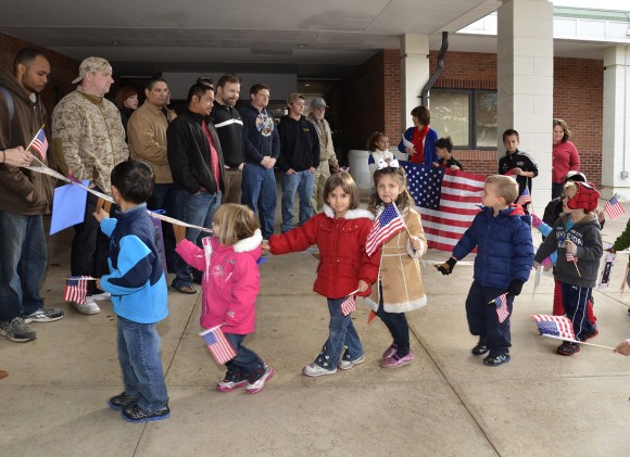 Tunxis Early Childhood Center children are shown greeting student veterans at the end of the procession.